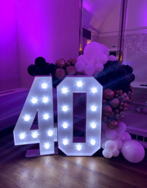 2 Light-up BABY letters with blue and white balloon garland for a baby shower