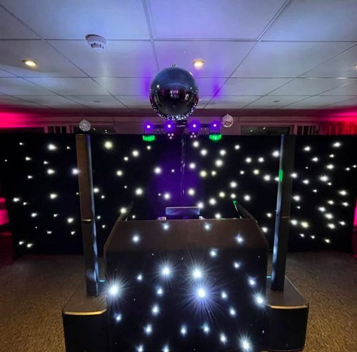 2 DJ booth with mirror ball and LED starlit dancefloor set up for an evening party