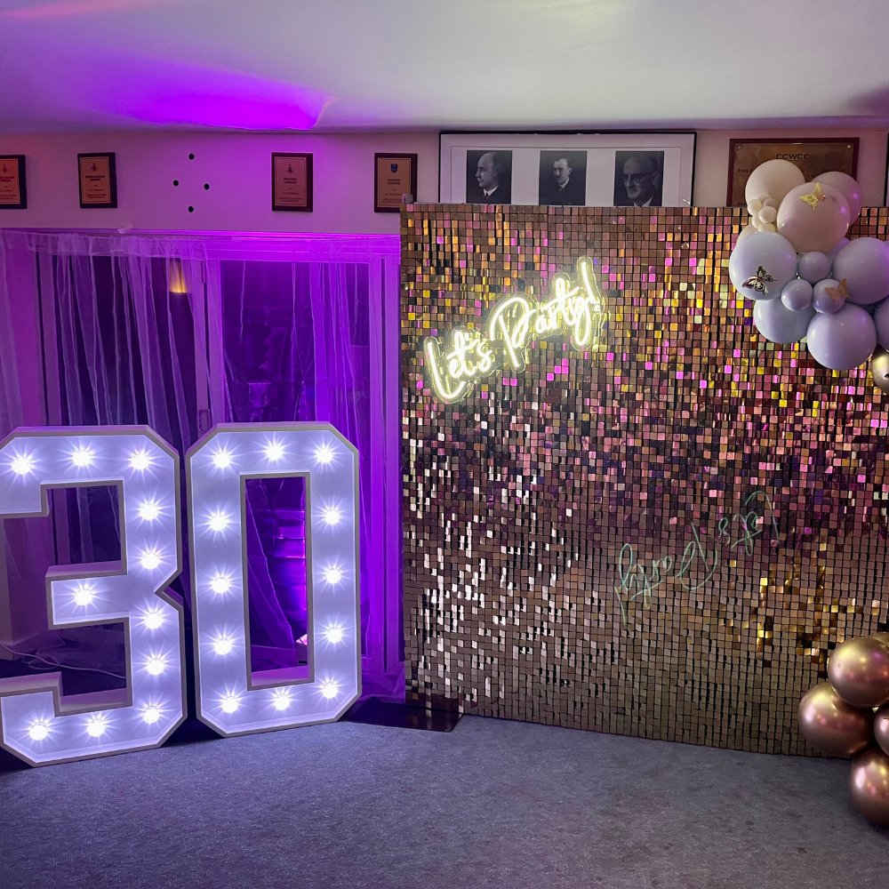 3 Light-up 30 numbers with gold sequin backdrop and Let's Party neon sign for a 30th birthday party