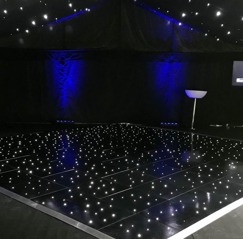 3 Black LED starlit dancefloor set up under a marquee with blue uplighting
