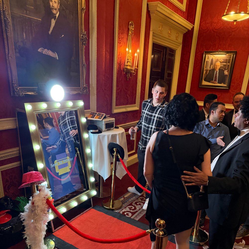 5 Guests enjoying a magic mirror photobooth at a private members club event