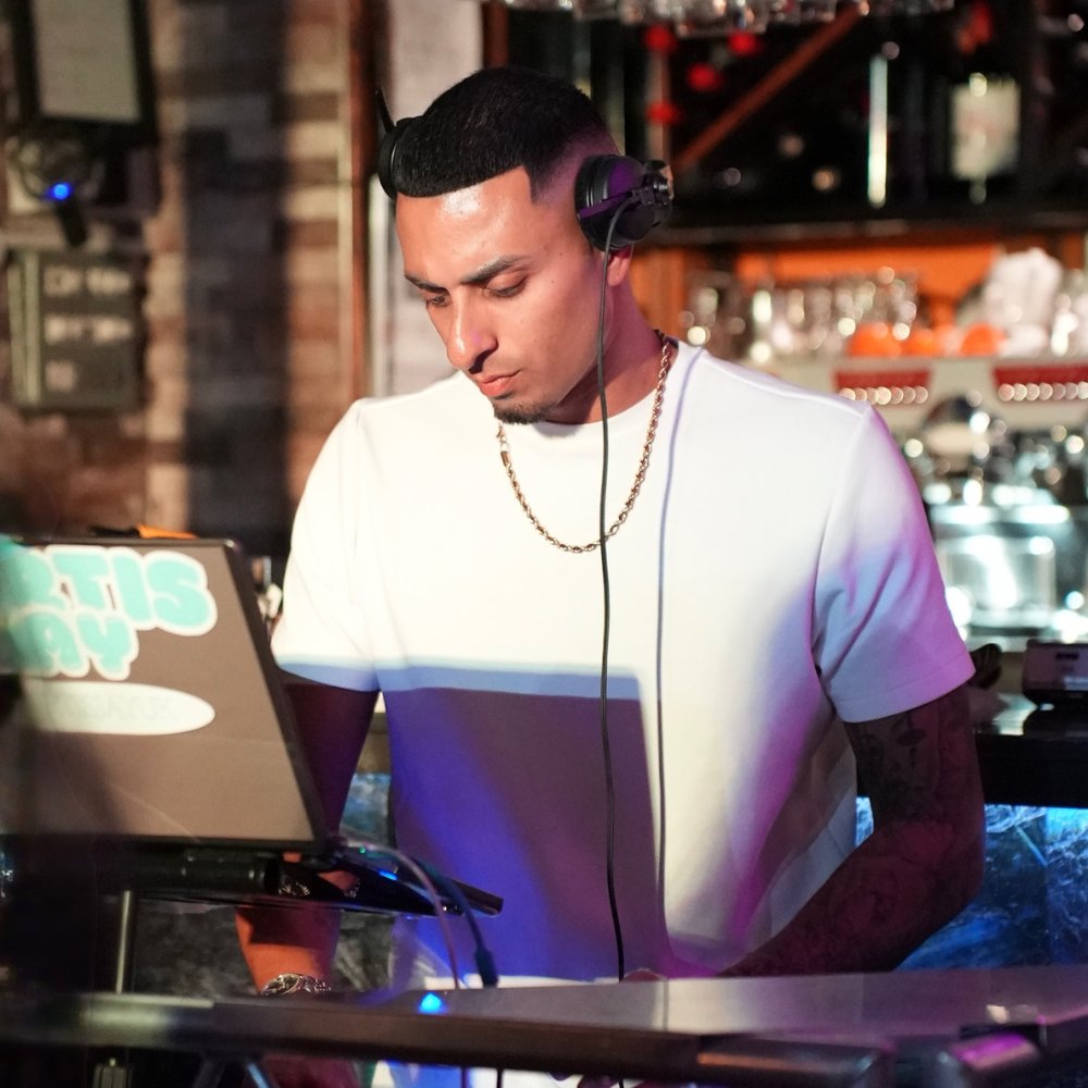 6 London Event DJs DJ performing on the decks at an evening party