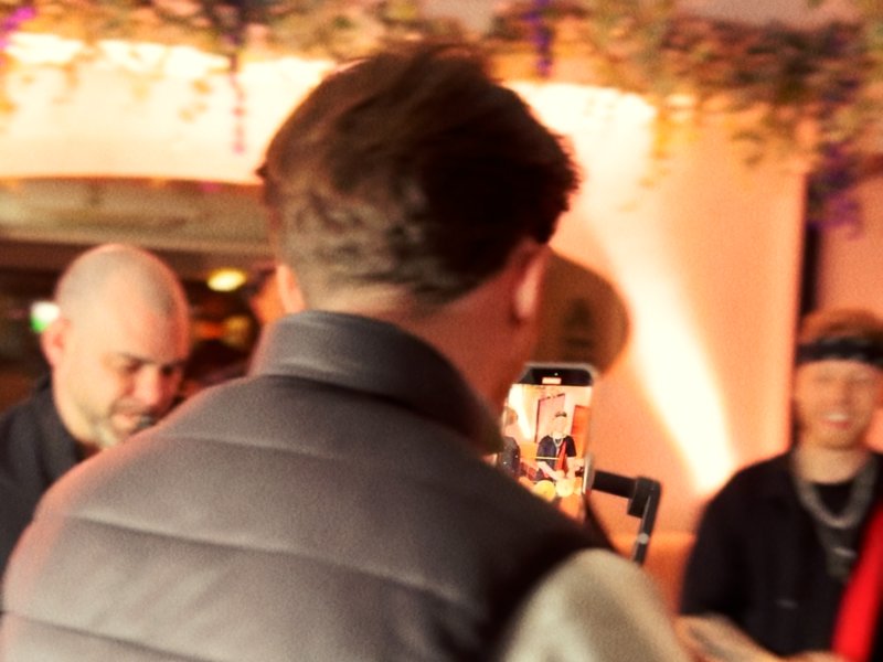 Content creator filming an event on a smartphone gimbal for social media