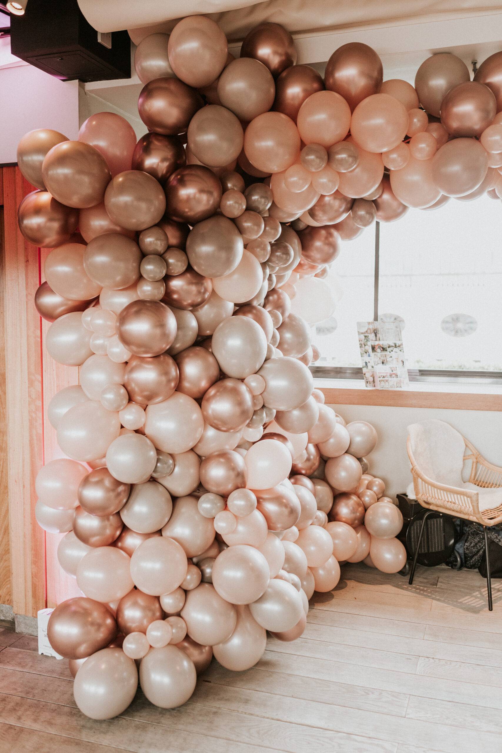IMG_6520 Rose gold and blush balloon garland arch decorating an event space window