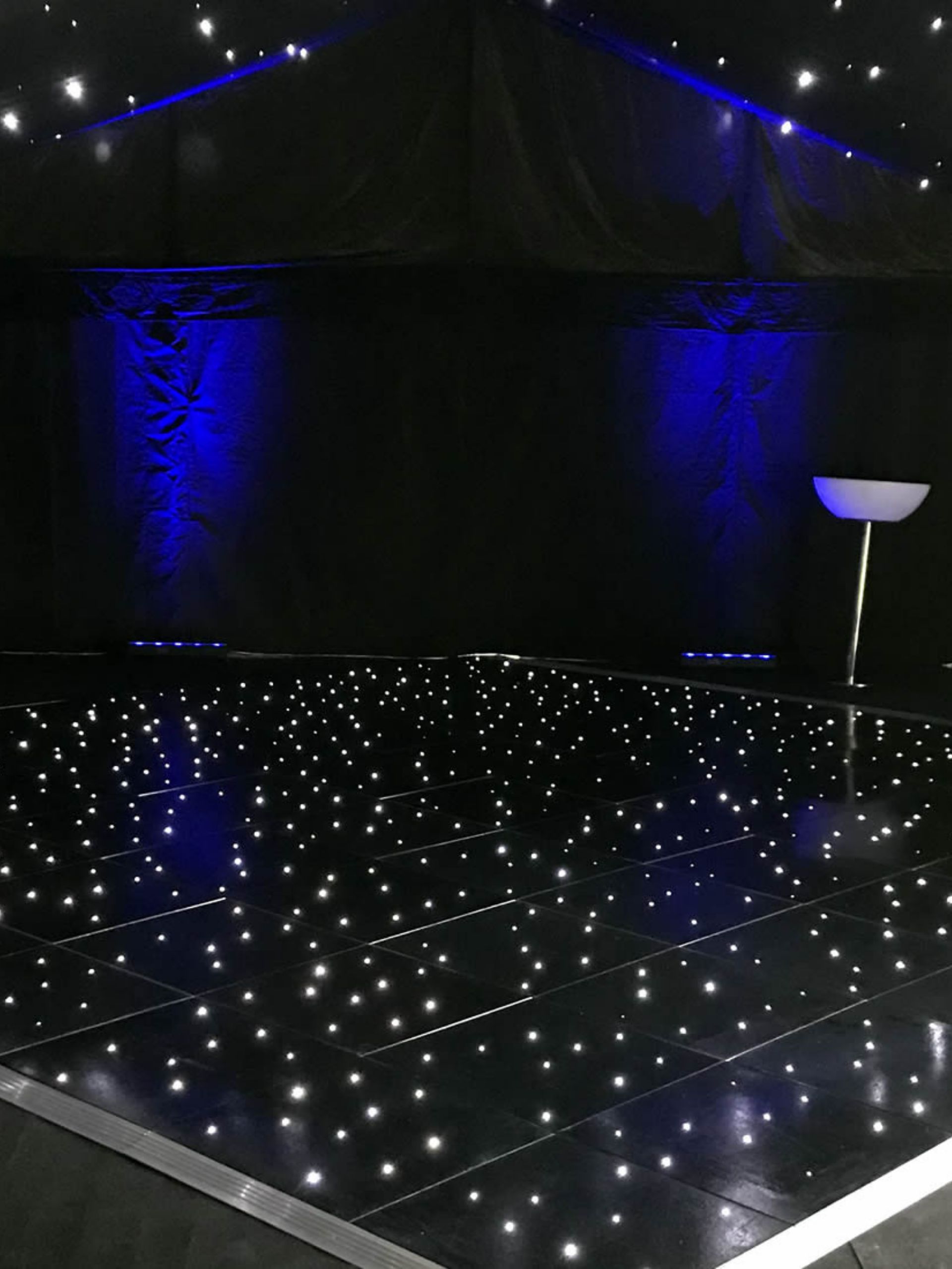 Black LED starlit dancefloor with blue uplighting in an empty function room