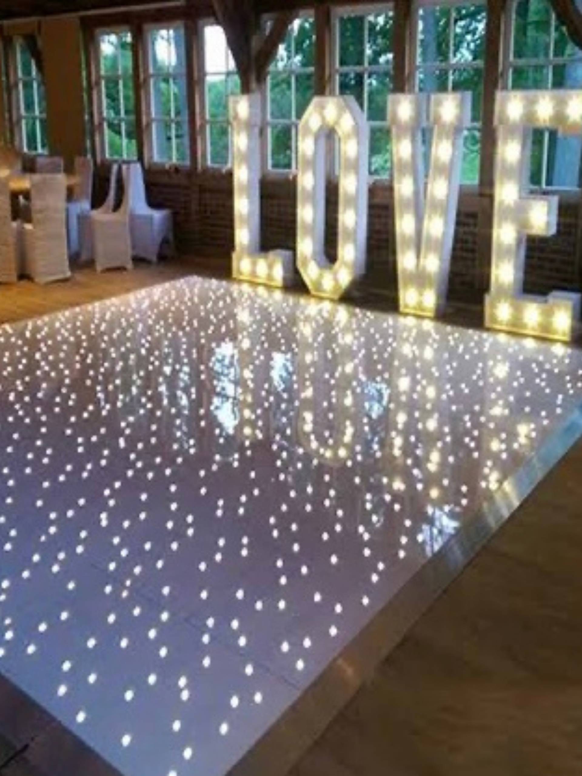 White LED starlit dancefloor with blue uplighting and a floor lamp in an empty room