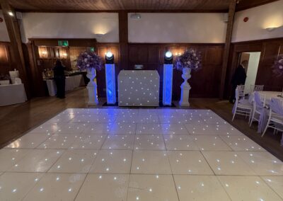 White LED starlit dancefloor and DJ booth set up with blue uplighting at The Ravenswood