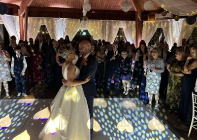 Bride and groom first dance on the LED starlit dancefloor at The Ravenswood with a heart light pattern