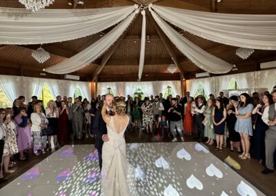 First dance on a white LED starlit dancefloor with heart-shaped lighting at The Ravenswood